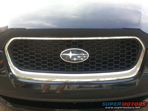 2008 Subaru Legacy front grille with honeycomb pattern and oval Subaru badge