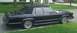 1991 Mercury Grand Marquis - A black 1991 Mercury Grand Marquis sedan with a vinyl top is parked on a residential street.