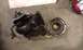 1987 Mazda RX-7 - Turbocharger and its associated housing components are shown laid out on a concrete floor.