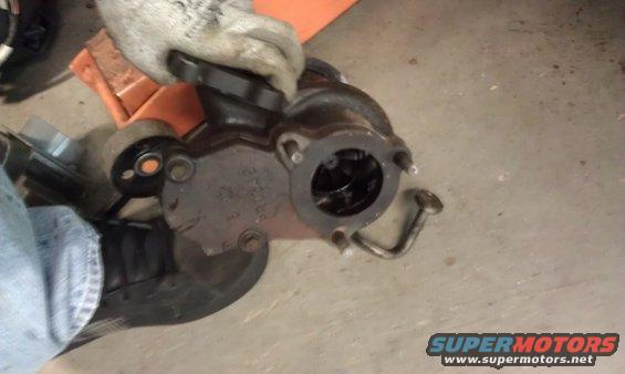 Someone holding a turbocharger part