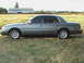 1999 Mercury Grand Marquis - This 1999 Mercury Grand Marquis sedan is seen from the side, parked in a grassy field.