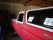 1978 Ford Bronco - A red and white 1978 Ford Bronco is shown in a garage, appearing to be in the process of restoration.