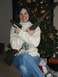 2003 Ford Crown Victoria - Woman poses with firearms near a Christmas tree, holding a pistol and a rifle.