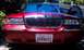 1999 Mercury Grand Marquis - Front view of a red 1999 Mercury Grand Marquis, its distinctive chrome grille and a California license plate.