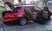 1999 Mercury Grand Marquis - Red 1999 Mercury Grand Marquis with doors and trunk open, parked curbside.