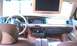 1999 Mercury Grand Marquis - Interior view of a car with a wood-trimmed dashboard and an overhead entertainment screen.