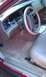 1999 Mercury Grand Marquis - Interior view of a car's dashboard and driver's seat, tan leather and wood accents.