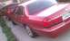 1999 Mercury Grand Marquis - Red Mercury Grand Marquis parked next to another red vehicle. License plate 6RVN601.