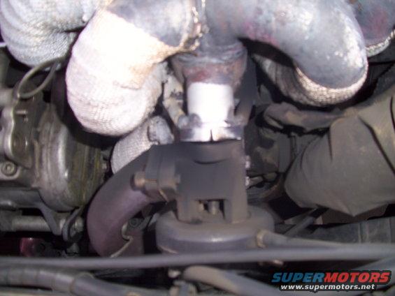 Close-up of exhaust manifold pipes and turbocharger assembly with heat wrap