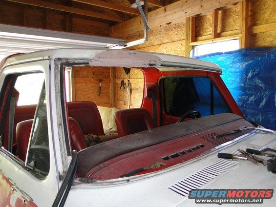 Interior of a 1978 Ford Bronco with red seats and a white roof