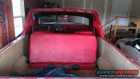 Red bench seat in the rear of a 1978 Ford Bronco