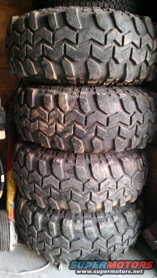 four large, knobby off-road tires stacked up
