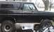 1979 Ford Bronco - Side view of a black SUV with chrome trim and BFGoodrich tires, possibly a 1978 model.