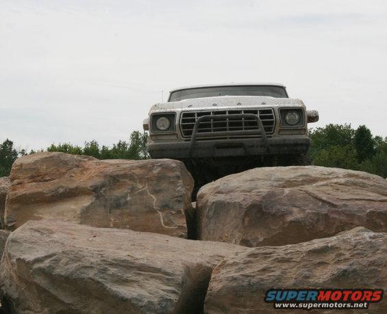 1978 Ford Bronco climbing over large rocks