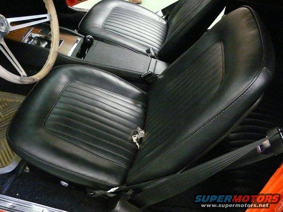 1968 Chevrolet Camaro interior with black vinyl seats and wood-grain trim