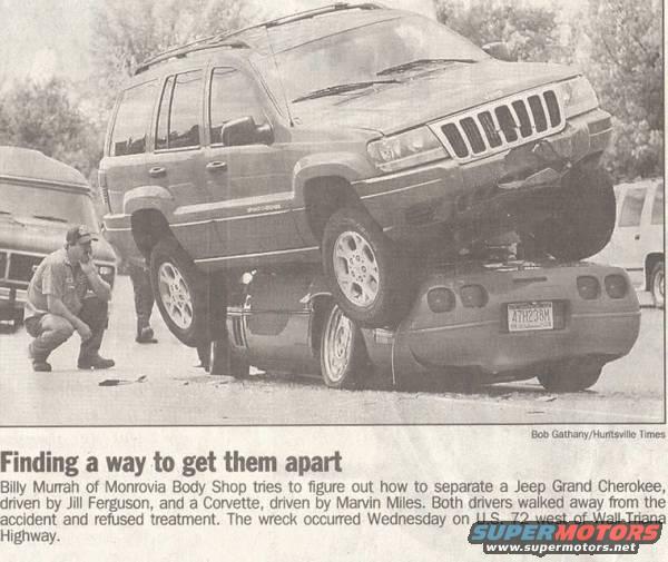 Jeep Grand Cherokee resting on the rear of a Chevrolet Corvette after an accident. A man kneels nearby