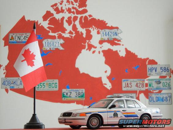 Model police car with Canadian flag and map of Canada with license plates