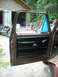 1978 Ford F-250 - The interior door panel of a truck, with a motorcycle and garage visible outside.