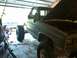 1983 Chevrolet C/K Pickup - This 1983 Chevrolet C/K Pickup truck is undergoing modifications in a garage, oversized tires and an open hood.