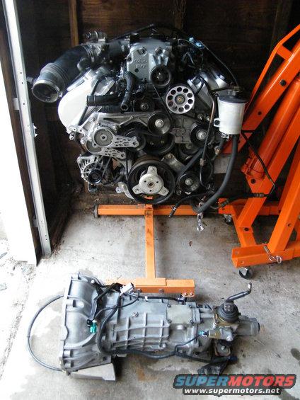 Engine and transmission assembly on orange engine stands