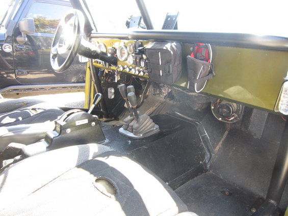 Interior view of off-road vehicle with multiple shifters and gauges