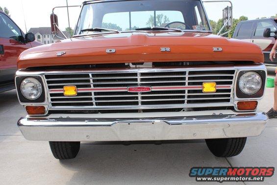 1969 Ford F-250 front grille with orange paint and chrome bumper