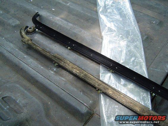 Door seal next to a new one, on a truck bed