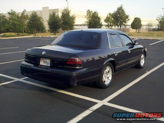 Dark blue 1999 Mercury Grand Marquis sedan, rear view, with custom wheels