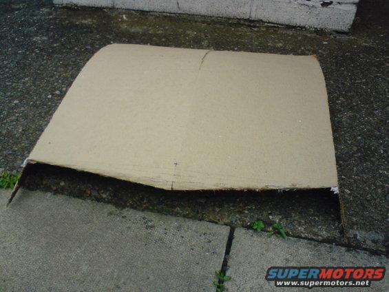 Cardboard piece on concrete with a Supermotors watermark