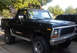 1979 Ford Bronco - A black 1978 Ford Bronco is parked outside on a sunny day, showing its off-road modifications.