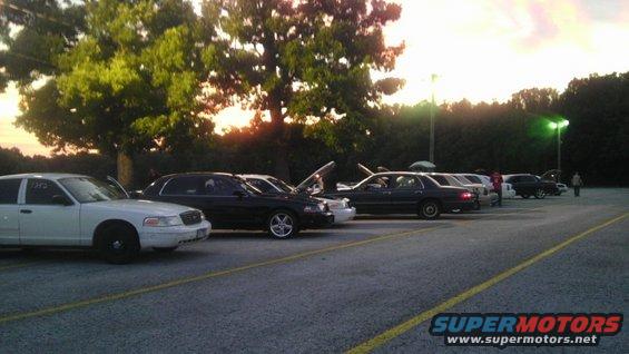 White 2000 Mercury Grand Marquis parked side-by-side with other sedans