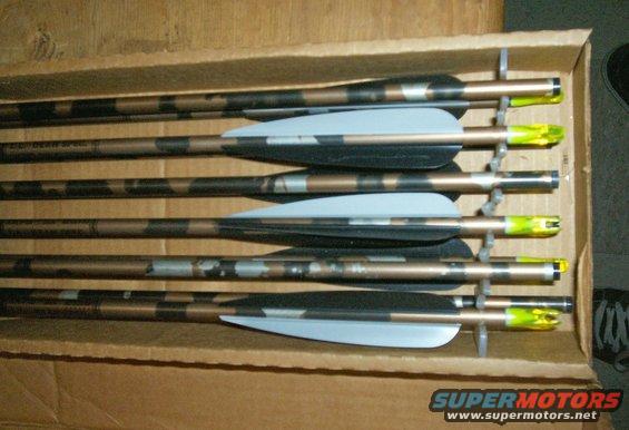 Box of six camouflage arrows with light blue fletching and yellow nocks
