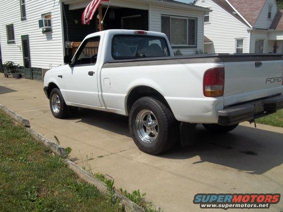 White Ford pickup truck side view with chrome wheels