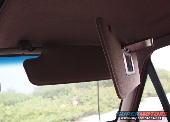 Brown sun visor with vanity mirror, interior view from passenger side