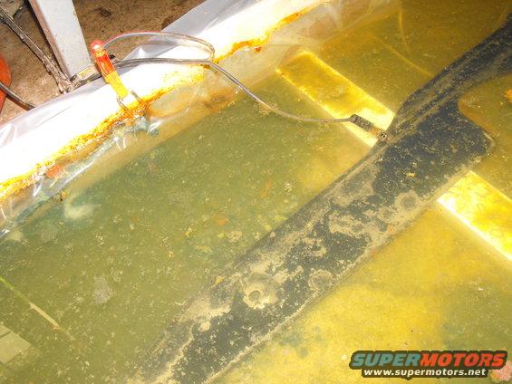 dscf2321.jpg I'd recommend you read his procedure in detail, but basically theres the positive charger clamp attached to the sacrificial BBQ skewer and the negative clamp sumberged and attached to the rad support top plate.