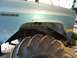 1983 Chevrolet C/K Pickup - Close-up of a light blue truck fender and a massive tractor tire, showing "2500" badging.