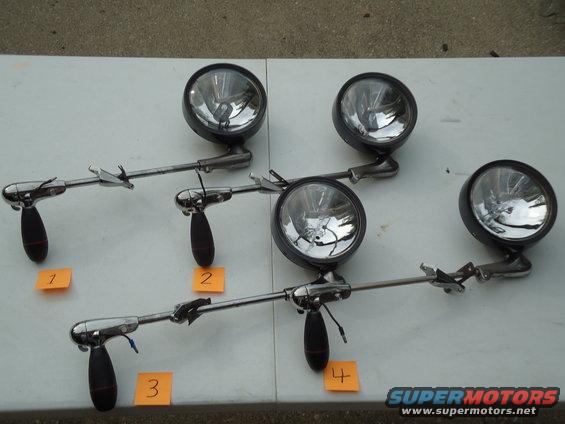 four vintage fog lights, numbered 1 through 4, laid out on a table