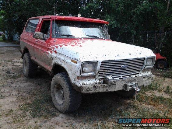 1979 Ford Bronco, 3q-front view, red and white with flame decals and mud