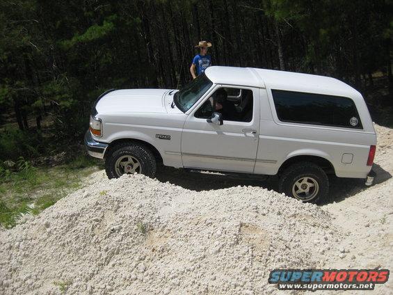 White 1994 Ford Bronco on a dirt pile