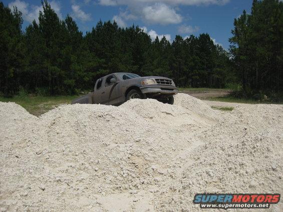 Gray pickup truck on a dirt mound, 1997 model year