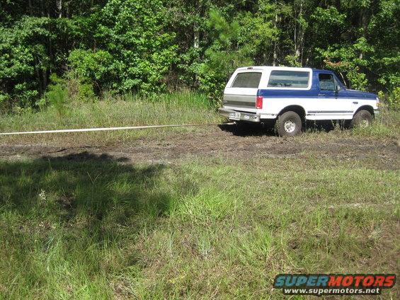 1994 Ford Bronco, rear view, white and blue, being towed