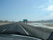 1992 Ford Taurus - Driving on a highway towards the Nevada Welcome Center with a body of water to the right.