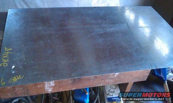 Sheet metal measuring 28x48, marked '6 GAL', on a wooden workbench