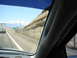 1992 Ford Taurus - View from inside a vehicle driving on a highway with a large truck ahead and a rocky hillside to the side.