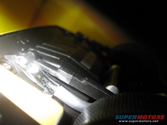 Close-up of black plastic car interior component with yellow exterior visible