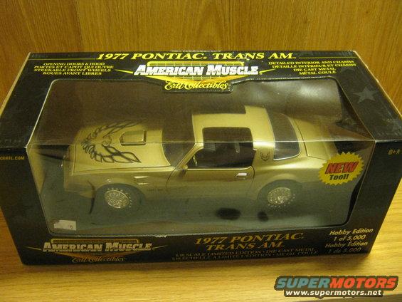Gold 1977 Pontiac Trans Am model car in its original packaging. Box says 'American Muscle' and '1 of 5,000'