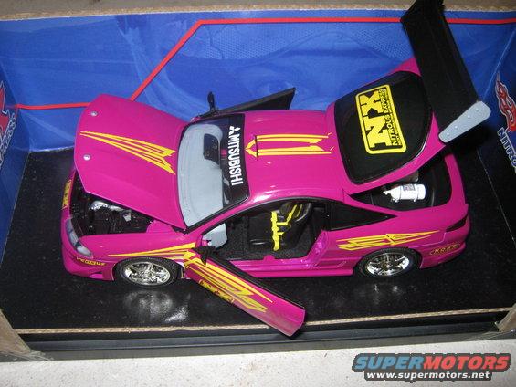 Pink toy car with yellow racing stripes and open hood and doors
