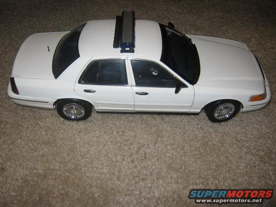 White police car model with roof rack, seen from the side