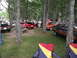 1978 Ford Mustang II - Several classic cars are on display in a wooded area at a car show.