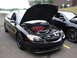 1992 Ford Taurus - Black Ford Taurus with hood open, revealing its engine and red intake manifold.